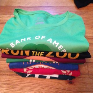 pile of t-shirts from races in multi-colors
